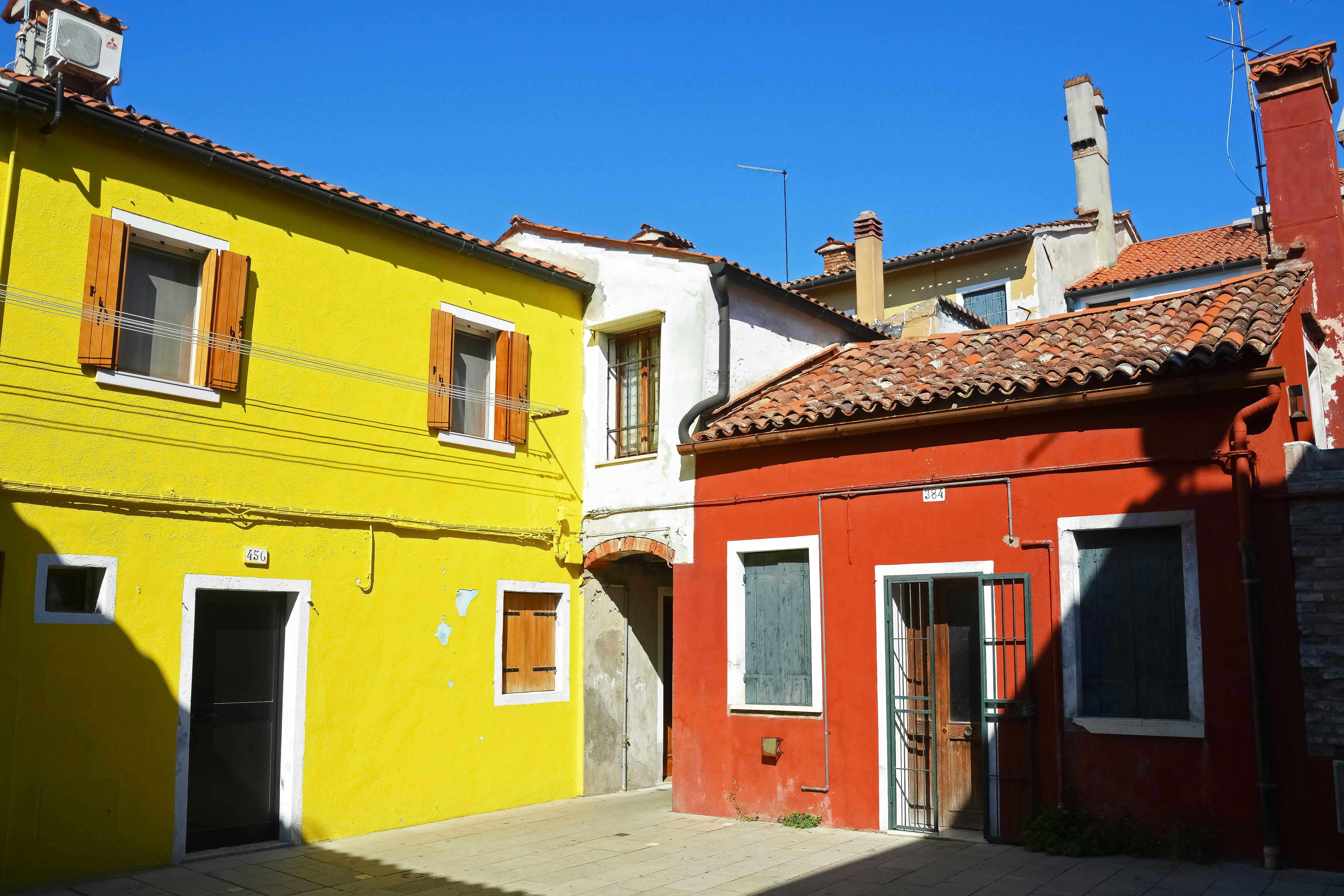 yellow and red concrete house under blue sky during daytime